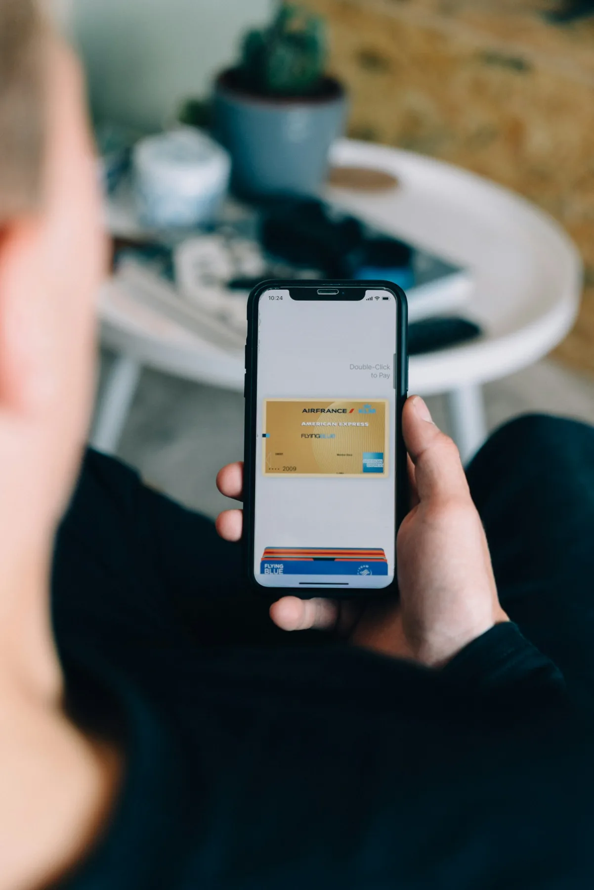 A resident holding a phone with a digital wallet open.